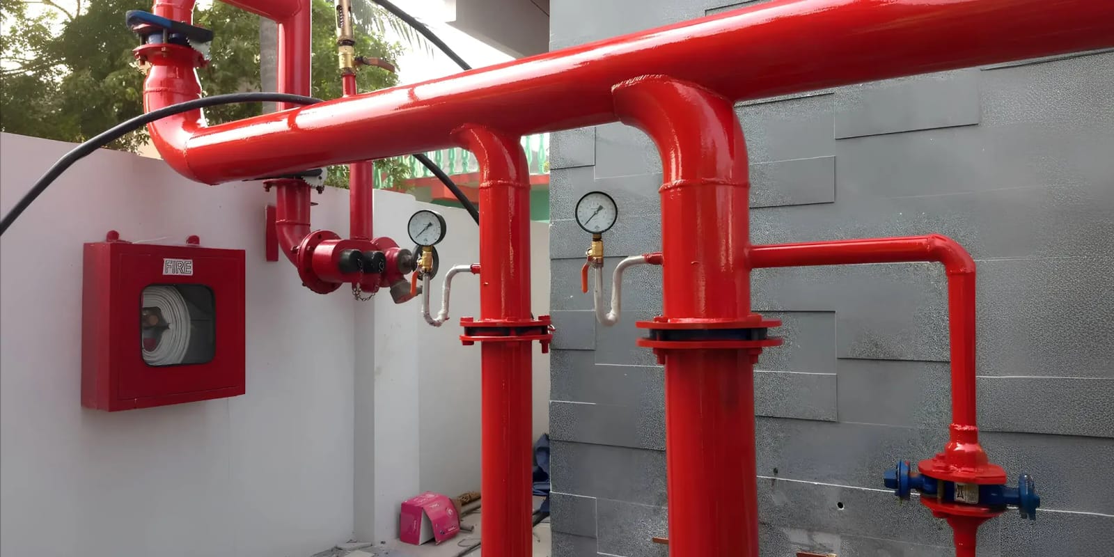 Installed fire hydrant piping with landing valves, pressure gauges and a hose reel box